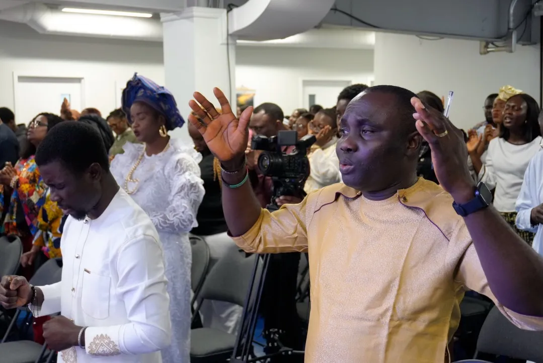 Members worshipping with hands raised