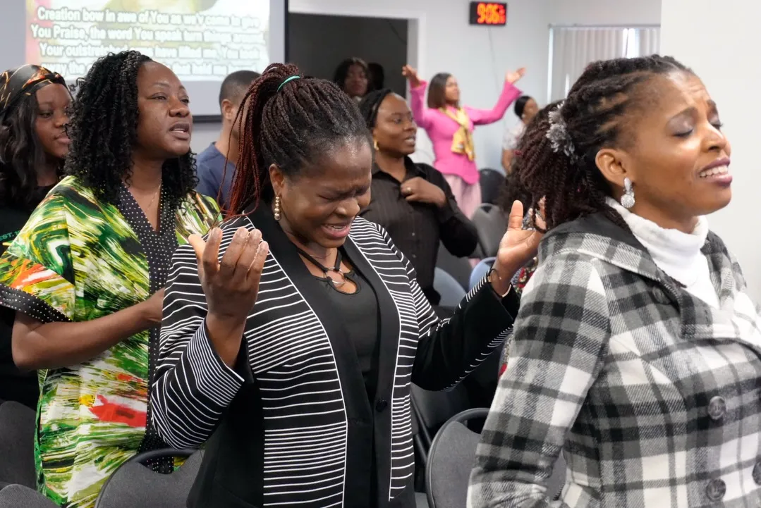 Women praising God with raised hands