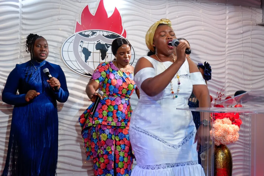Three singers leading worship