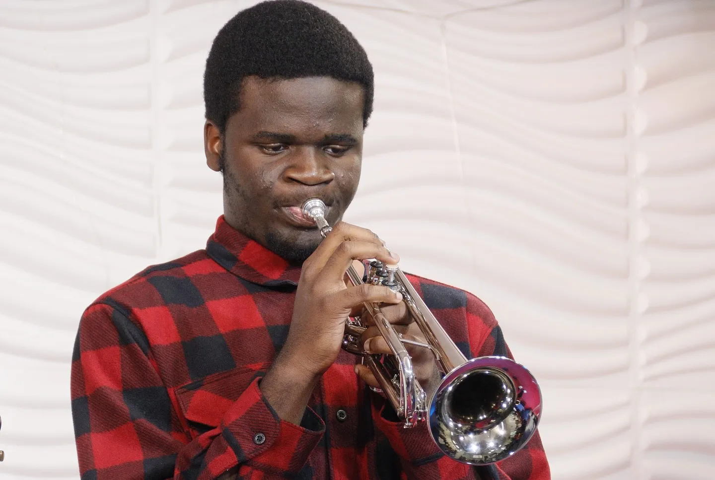 A young musician playing the trumpet during worship