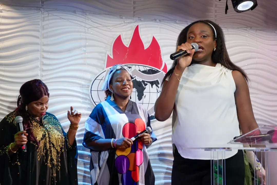 Women leading songs together on stage
