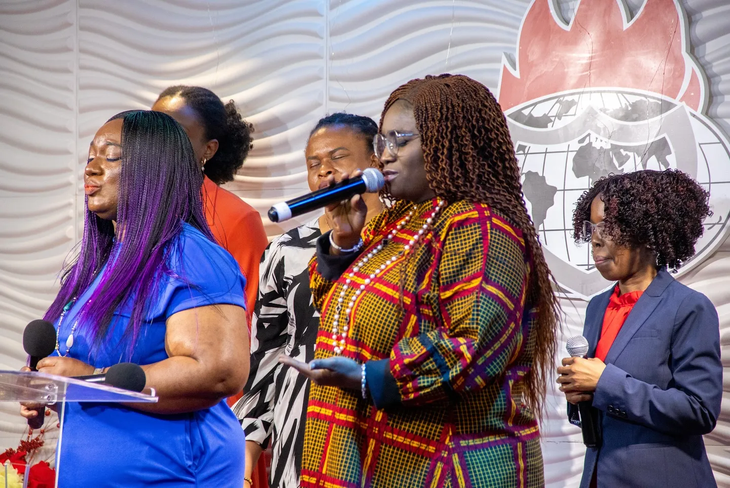 Worship leaders singing together on stage